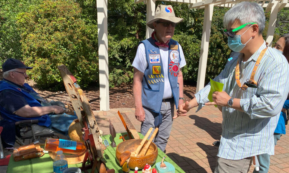 Alan Huntzinger answers questions about woodcarving and his whittling projects at the Saratoga Blossom Festival.