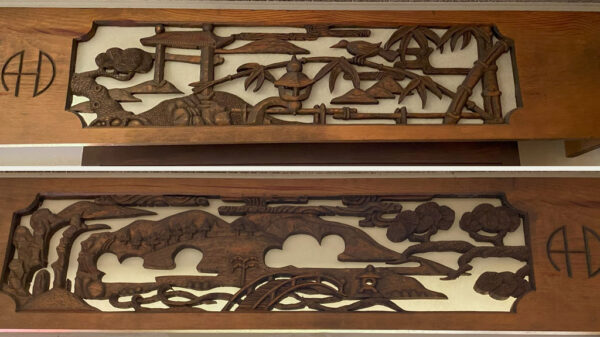 Large wooden panels featuring bamboo and birds carved by Alan Huntzinger.
