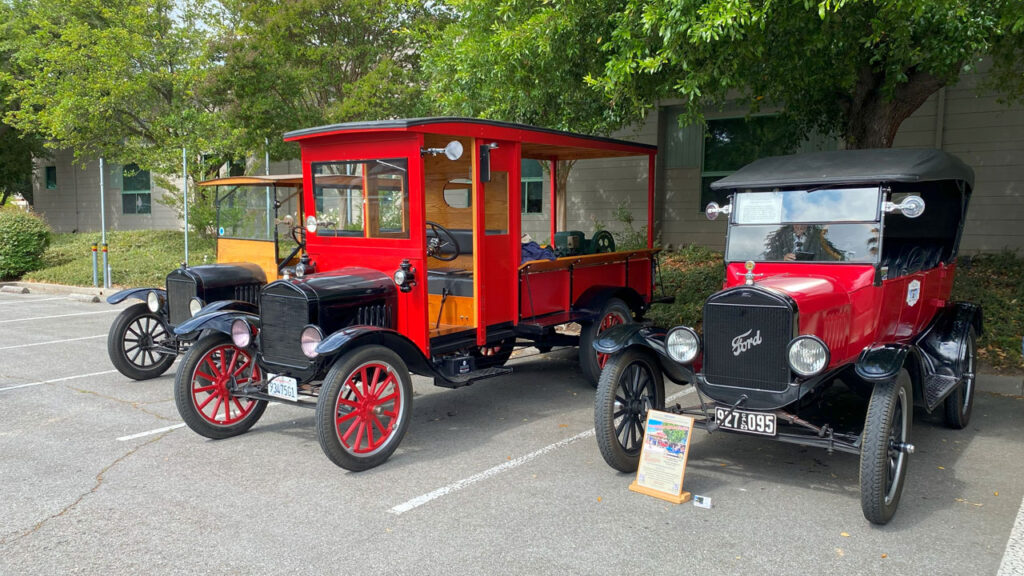 Three antique cars