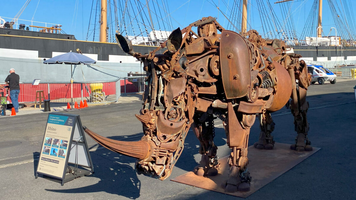 An art sculpture of a rhino assembled from random metal parts.