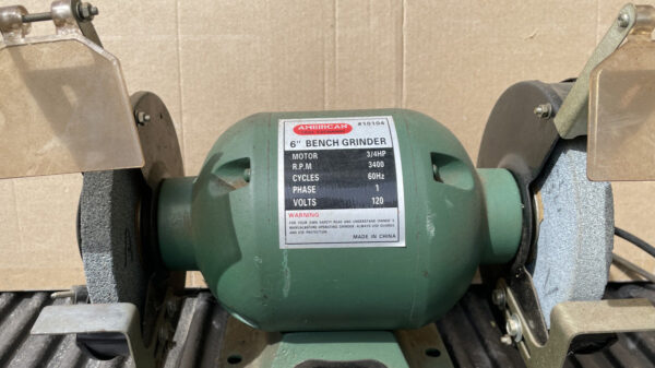 6" bench grinder with two sharpening wheels. Painted green.