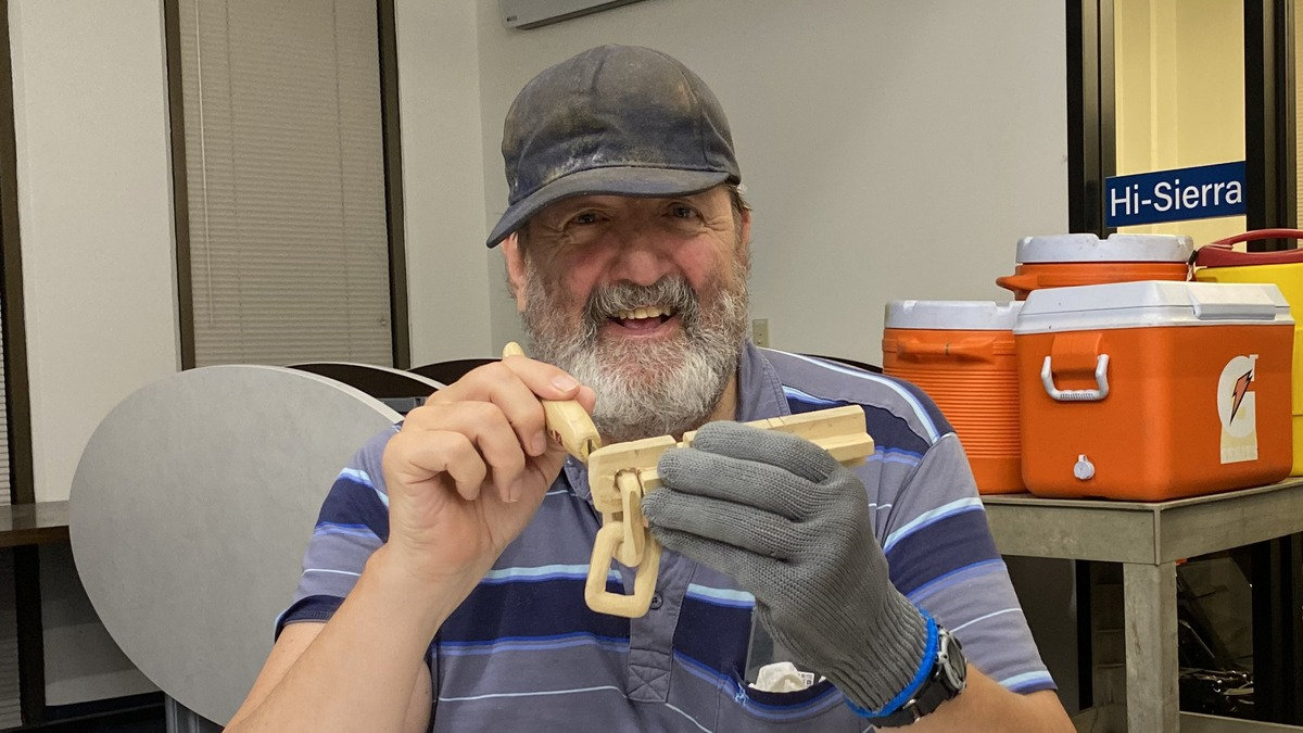 Bill Peekema uses a carving knife on an interlocking wooden chain during a September 2026 Santa Clara Valley Carvers meeting in San Jose, California.