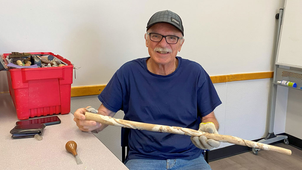 Bruce Dahl started carving a walking stick.