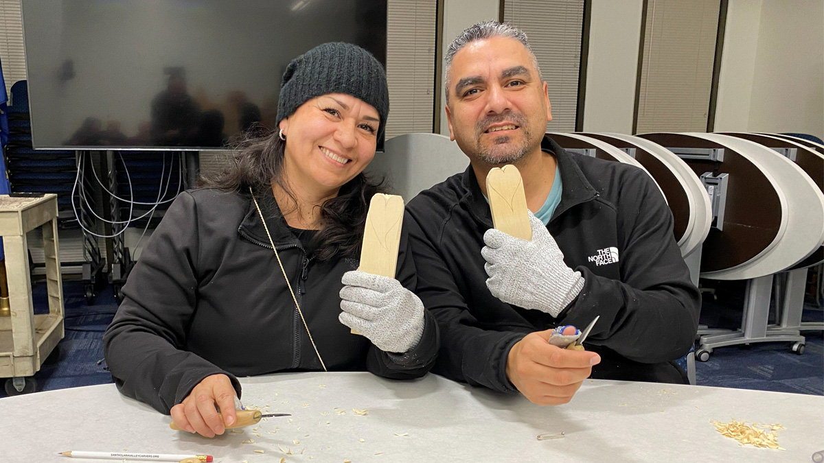 Carolina and Anthony are carving hearts from basswood at the Santa Clara Valley Carvers club's carving workshop.