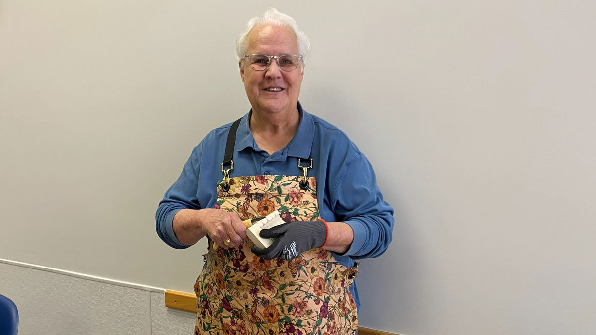 Connie made a leather apron with crisscrossing straps.