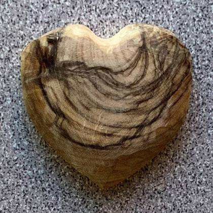 A simple heart carved from olive wood by Connie Wilson.
