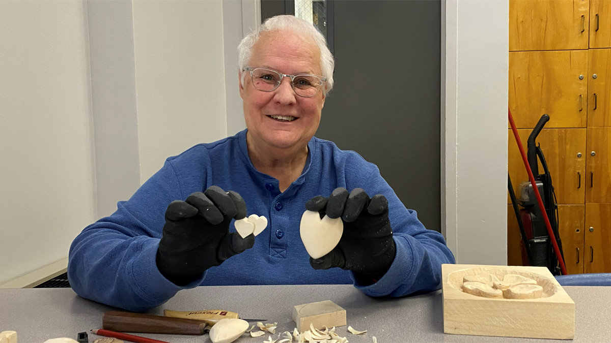 Connie shows two heart-carving projects she recently completed.
