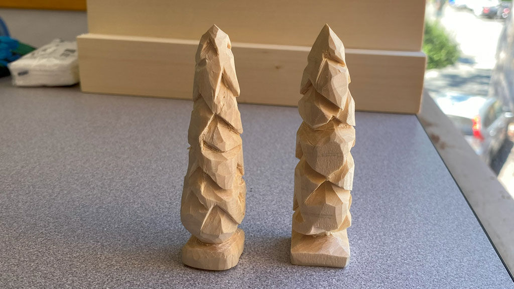 Two little trees carved from basswood.