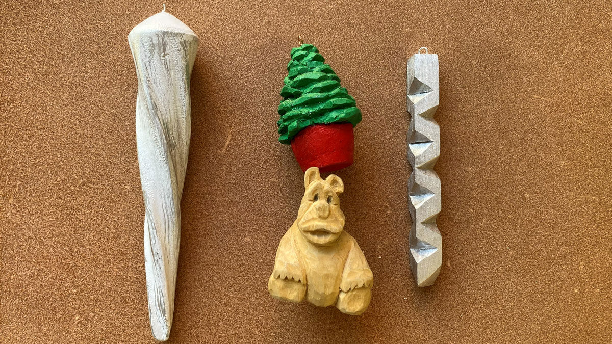 Two carved and painted icicles, one carved red tree, and a cute bear carved from basswood by Dan.