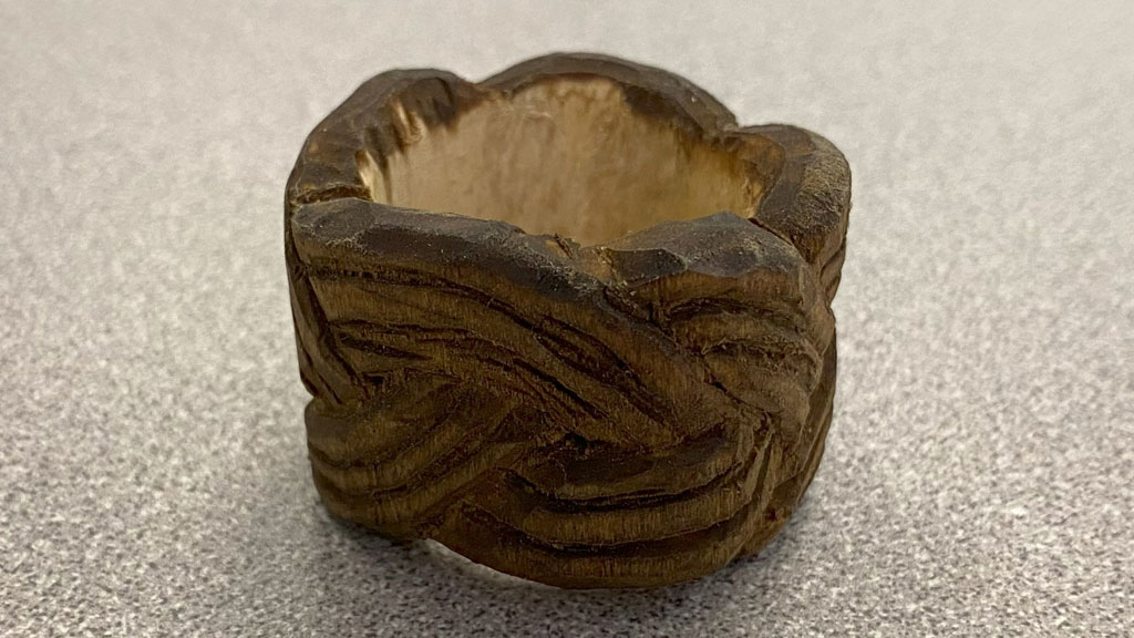 Neckerchief slide in a shape of a rope nut carved from basswood and stained by Dan Brady.
