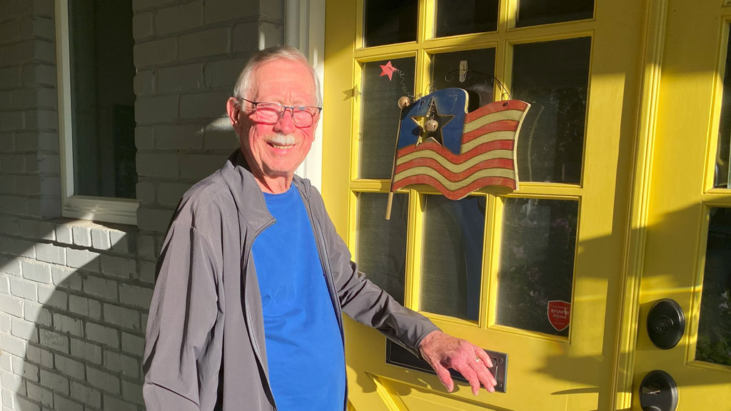 David Osterlund is near the door with the wooden US flag he made years ago.