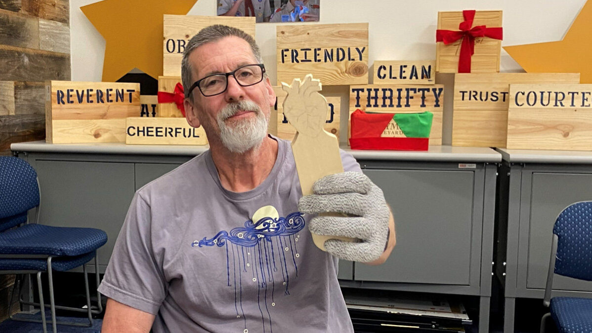 David works on carving a stylized heart from basswood.