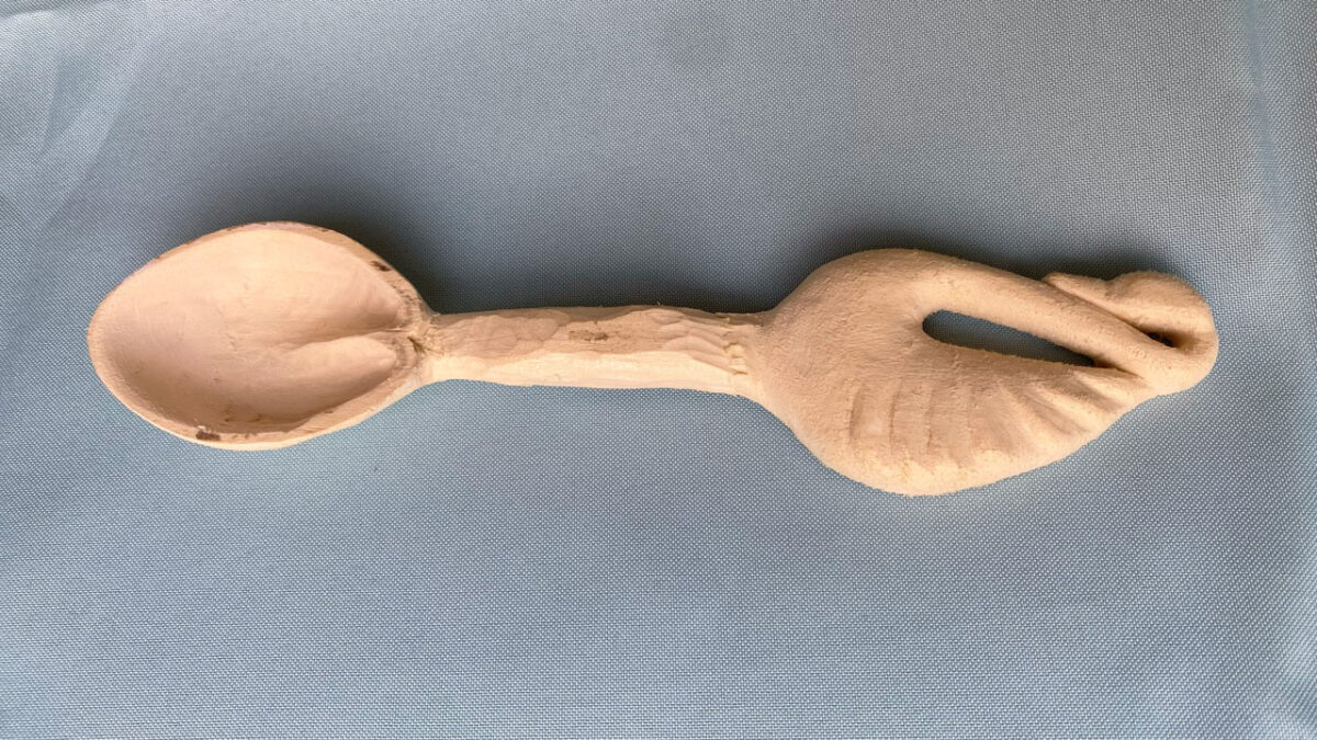 A work-in-progress piece: a wooden spoon with a swan design.