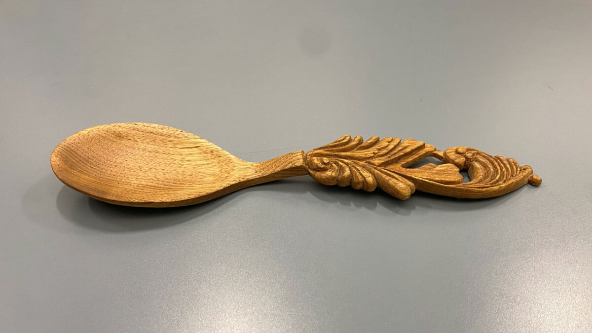 Decorative spoon carved from butternut and oiled by David Osterlund. It is about 12" long.