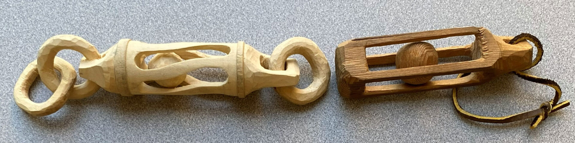 Two classic whittling projects carved by David Osterlund: a ball in a cage.
