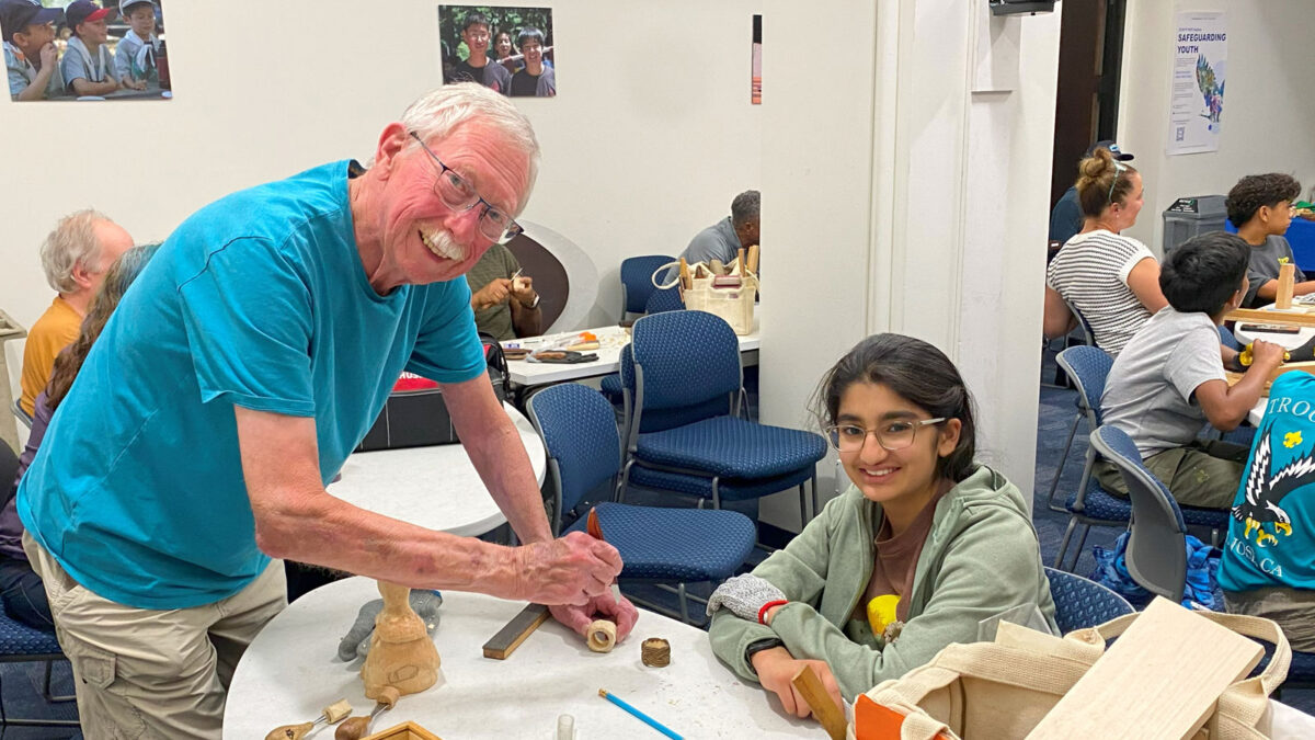 Sharing woodcarving experience across generations.