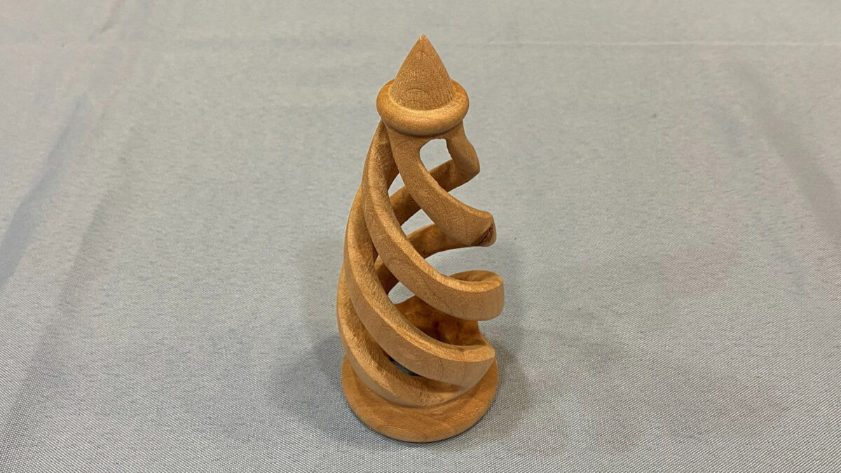 A turned and carved spiral sculpture, a Christmas tree ornament, by Dennis Lillis.