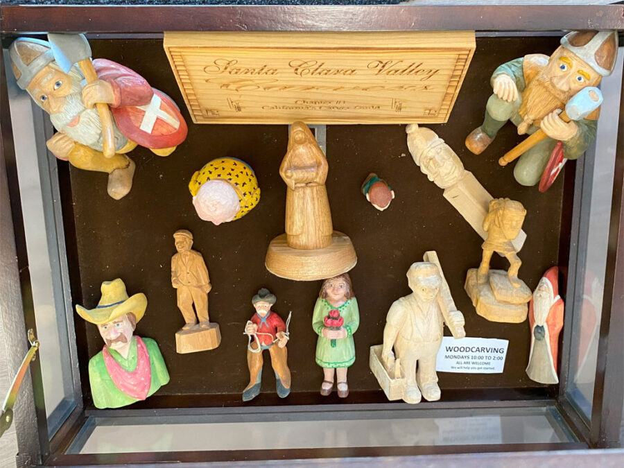 SCVC Woodcarving Display Case showing several carved vikings, santas, and cowboys, September 2023