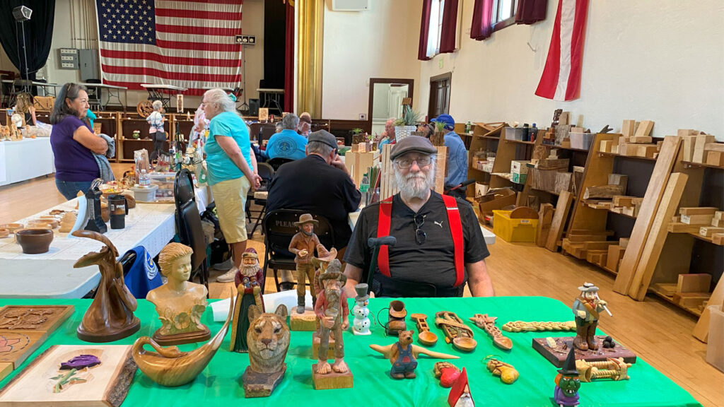 Don Bott demonstrates his woodcarved spoons at the TVC table during the woodcarving show in Pleasanton, CA.