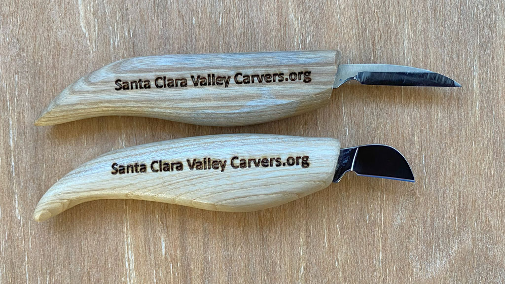 Two woodcarving knives. One is a BeaverCraft detail knife, and the other is a Flexcut chip carving knife.