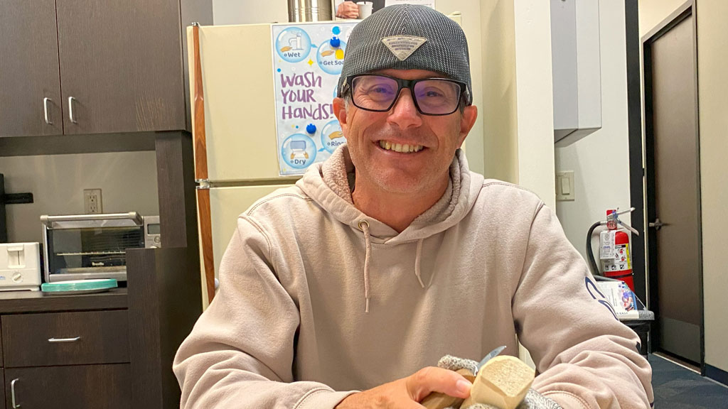 Dylan Fullington is carving a knight from a piece of basswood. He joined the Santa Clara Valley Carvers in April 2025.