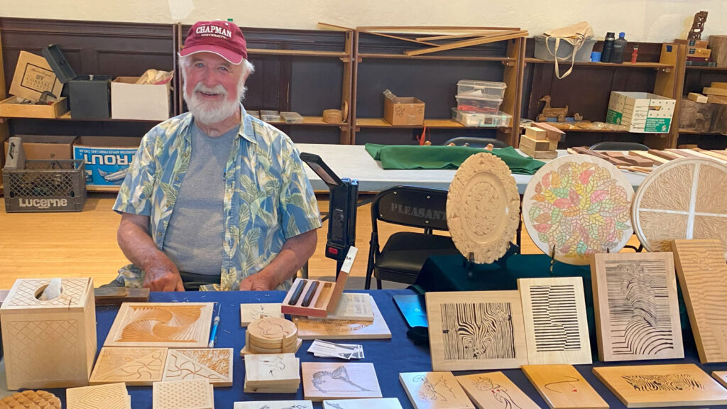 Ed Hesket filled his table with chip carving projects at the woodcarving show in Pleasanton, CA.