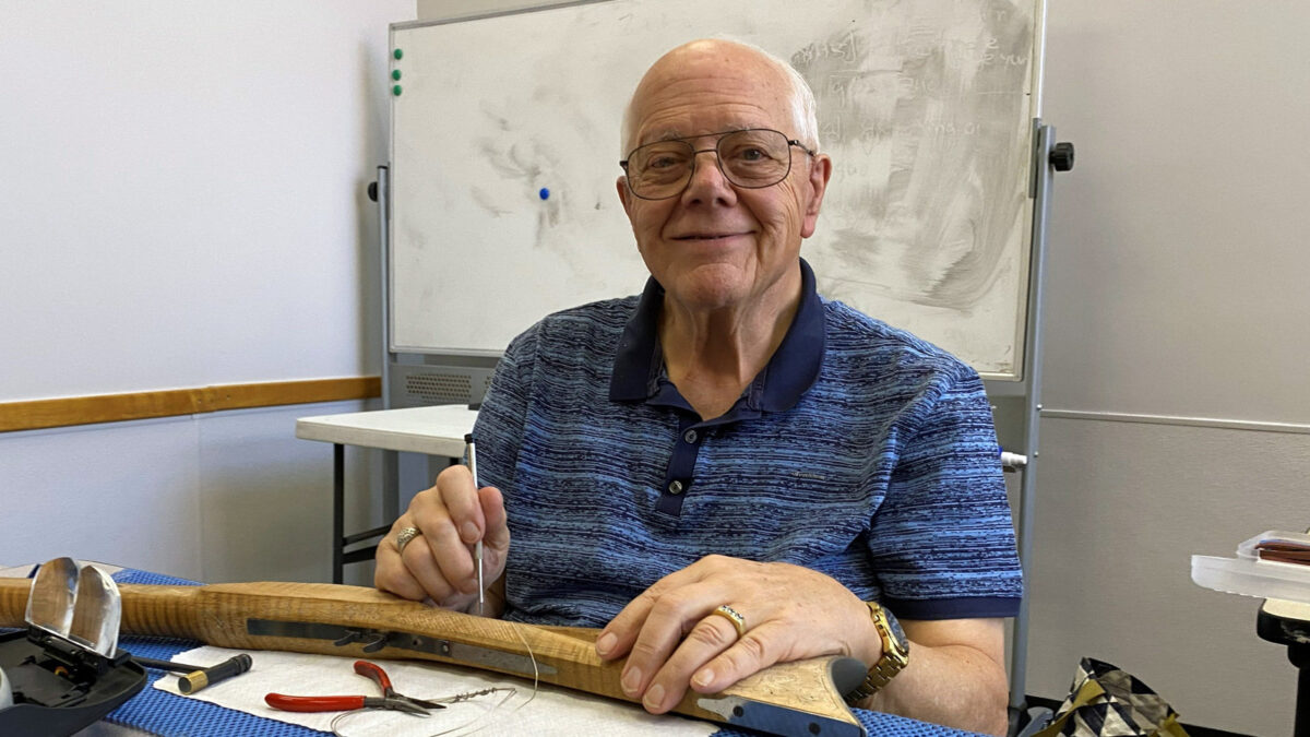 Gary is holding a pointy tool that he uses for silver wire inlay.