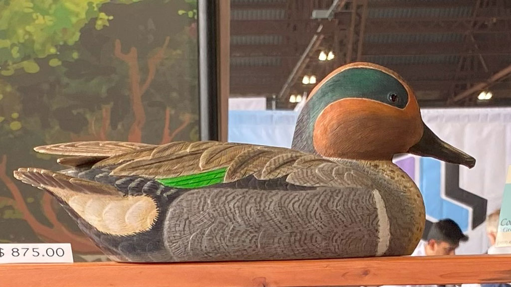 A duck carved from wood.