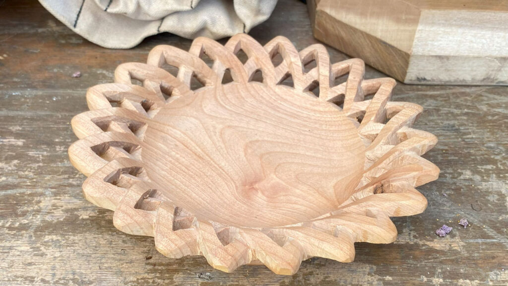 A wooden bowl with a Celtic knot rim by Jim Planting. Work in progress.