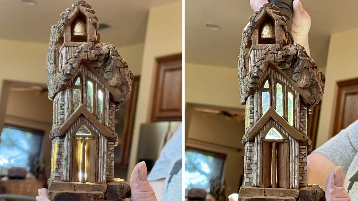 A miniature church carved from bark with embedded stained-glass windows.