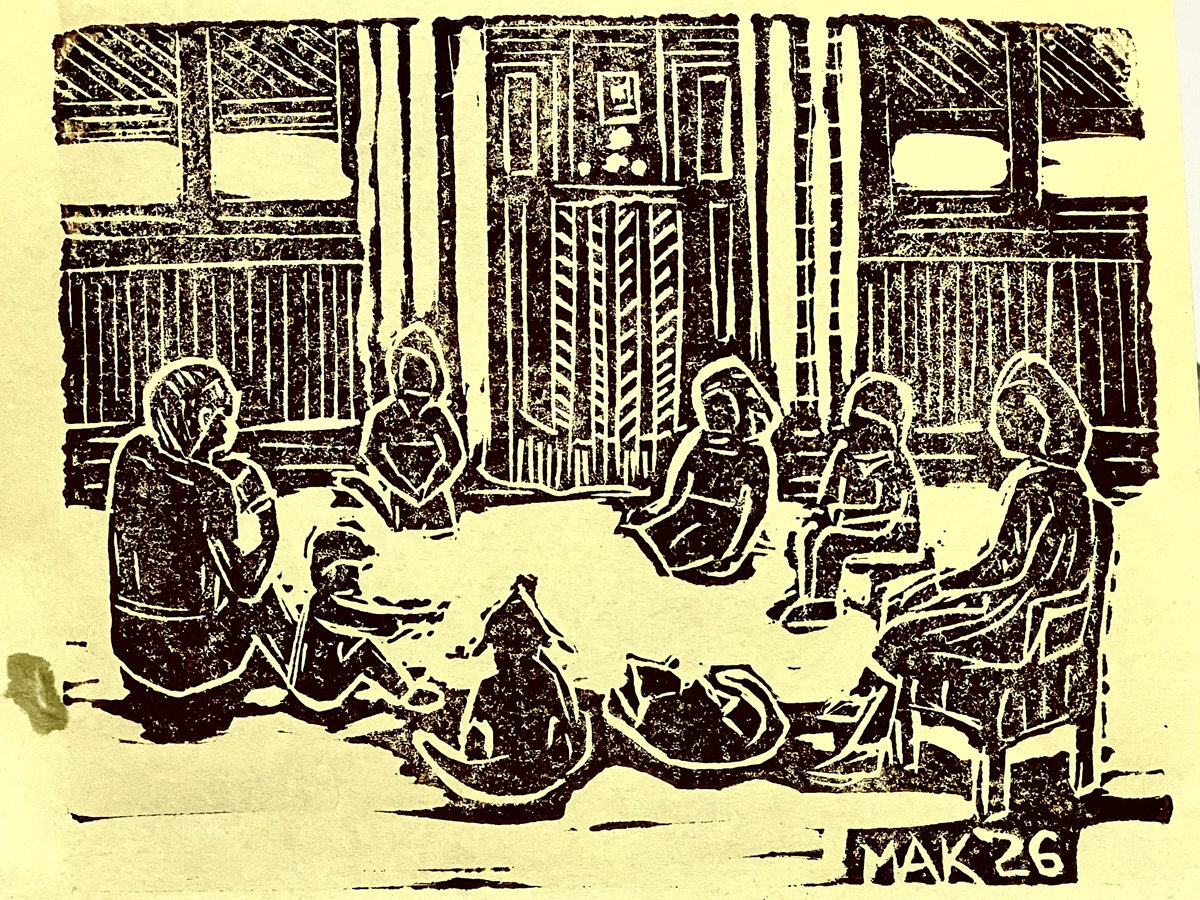 Monochromatic linoleum block print by Jordan Makower titled "Family Radio Time." The image depicts a memory-based scene of a family gathering indoors. Several figures, including adults and children, are seated in a relaxed semicircle on the floor and in chairs within a room with vertical wall paneling or bamboo siding. In the background, a large radio with vertical slats is visible. In the foreground, two curled shapes, likely dogs or cats, rest on the floor near the seated figures. The artist's signature "MAK `26" is carved into the bottom-right corner, indicating it was carved in 2026.