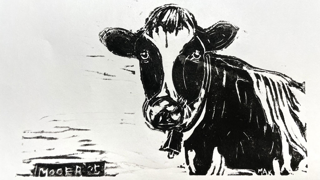 A linoleum block print with a cow design by Jordan Makower.