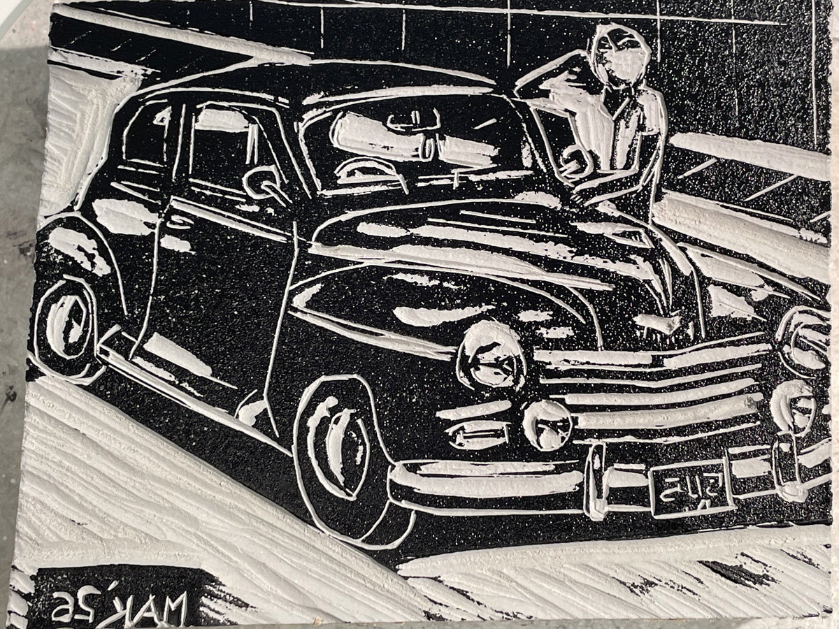 An inked linoleum block depicting a vintage sedan, identified by the filename as a Plymouth Deluxe, angled toward the right.