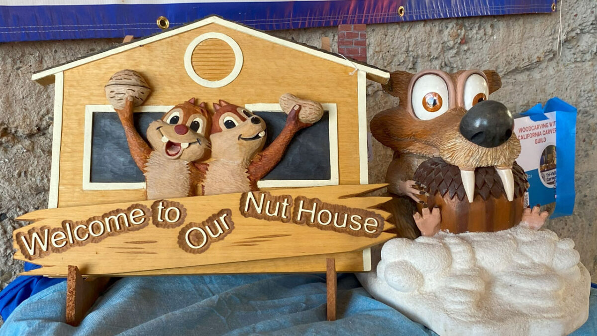 Cartoon animals holding nuts carved by Ken Morgan.