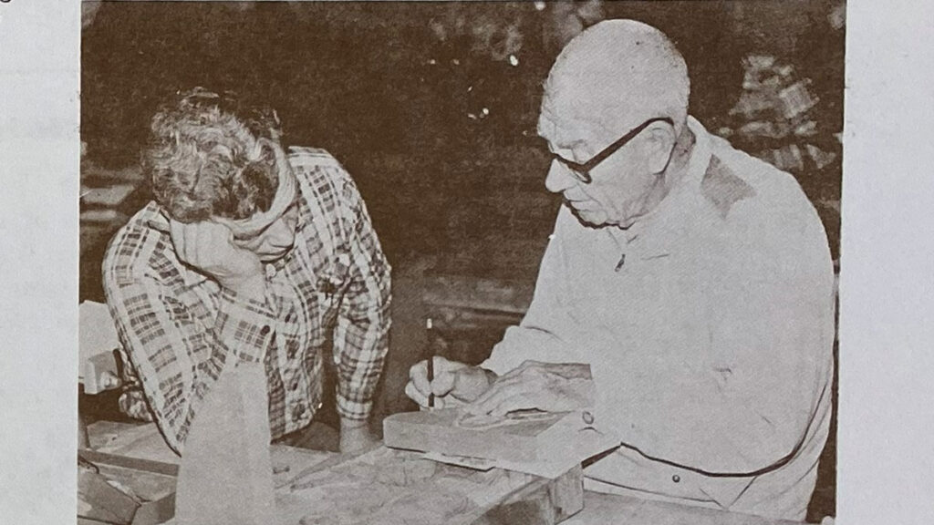 Lucien Dean Hertert is explaining woodcarving to a new SCVC member.