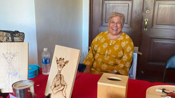 Maya runs the raffle program at the TVC Woodcarving Show in Pleasanton, CA. September 2025.