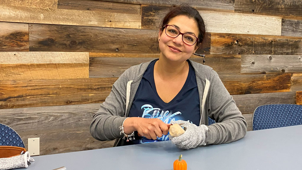 Mili Gupta is carving a pumpkin. She joined the Santa Clara Valley Carvers in May 2025.