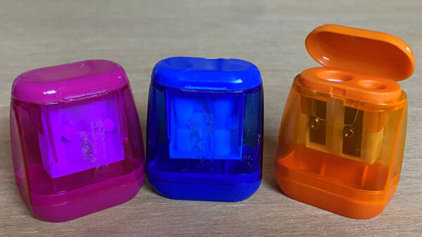Three plastic pencil sharpeners.
