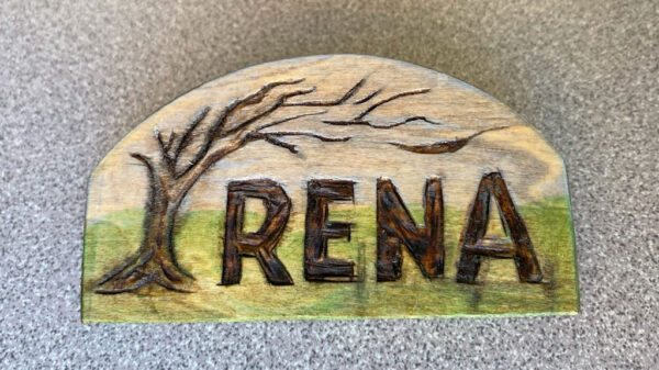 Colorful name badge with a leaning tree