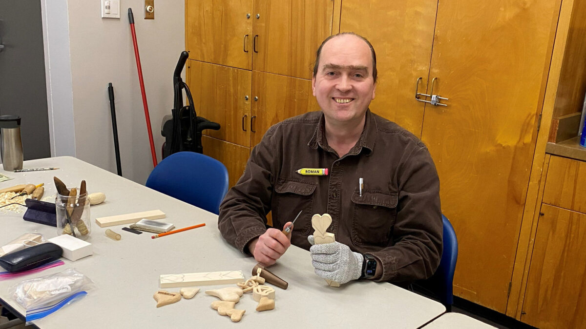 Roman shows a simple heart that he whittled from basswood.