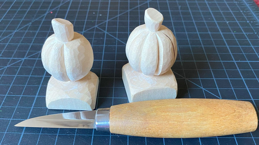 Two pumpkin carving guides with a whittling knife