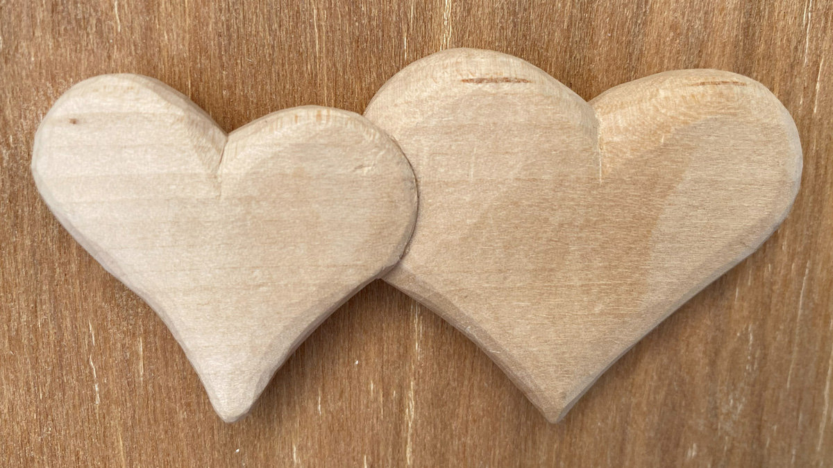 Two linked simple hearts whittled from basswood by Roman Chernikov.