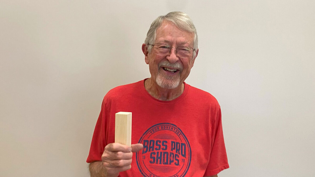 Ron Richards is holding a piece of basswood that he intends to carve.