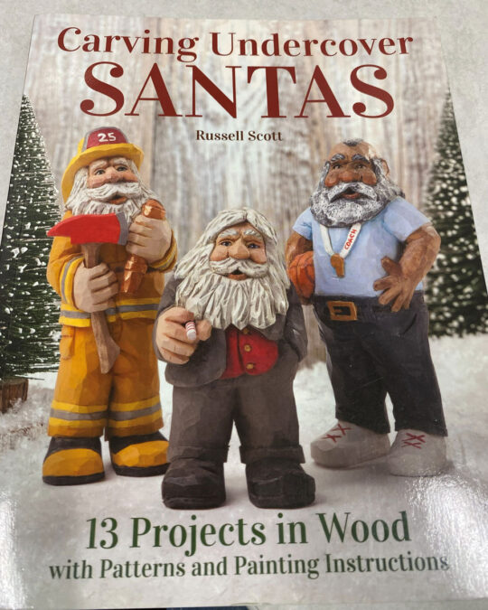 A book cover with three Santas in common-day outfits.