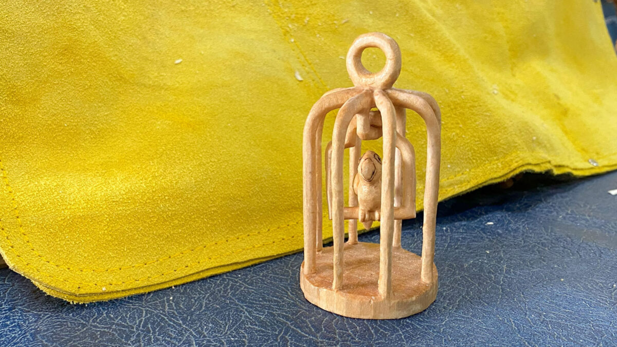 A bird in a cage carved from one piece of basswood by Scot Lang. The photo was taken for the woodcarving newsletter.