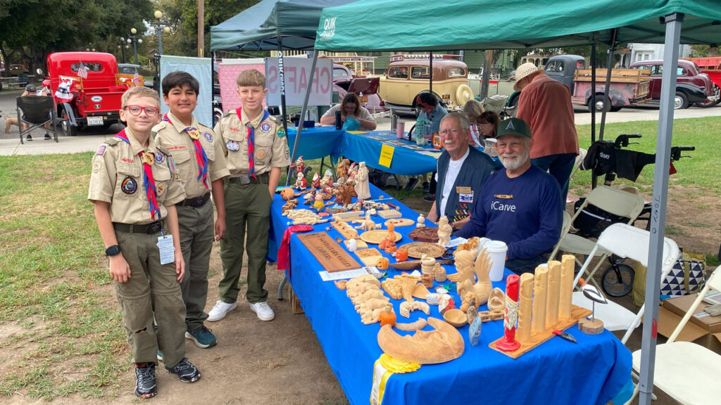 Scouts learn about woodcarving at Cars in the Park, 2025