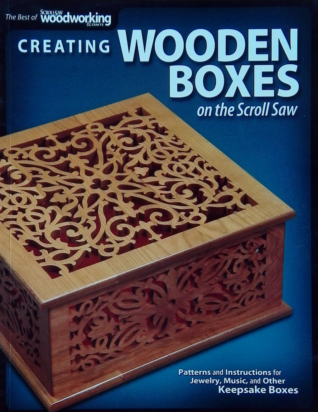 An image of a woodworking book cover: Creating Wooden Boxes On The Scroll Saw by ScrollSaw Woodworking; 2009, 127p