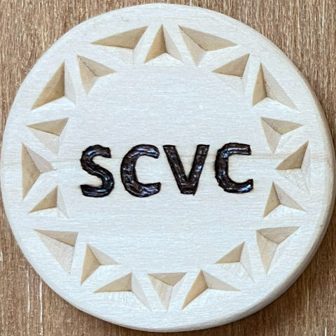 A round badge decorated with chip carving by Roman Chernikov, https://readNtry.com