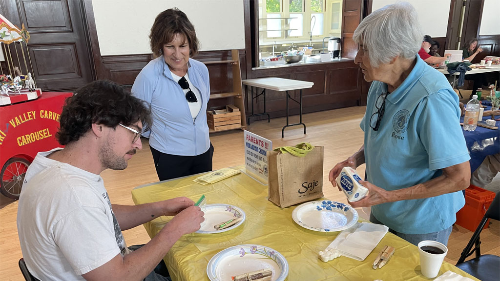 Rose Rodriguez is helping participants carve soap.