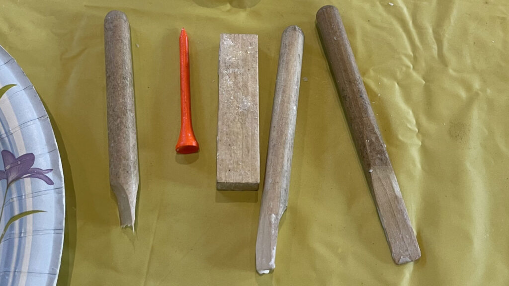 Wooden tools for soap carving include a chisel, a gouge, a V-tool, and a pointed tool, such as a golf tee.